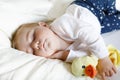 Cute adorable baby girl of 6 months sleeping peaceful in bed Royalty Free Stock Photo