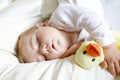 Cute adorable baby girl of 6 months sleeping peaceful in bed Royalty Free Stock Photo