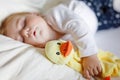 Cute adorable baby girl of 6 months sleeping peaceful in bed at home. Closeup of beautiful calm child, little newborn Royalty Free Stock Photo