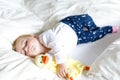 Cute adorable baby girl of 6 months sleeping peaceful in bed