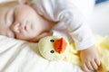 Cute adorable baby girl of 6 months sleeping peaceful in bed at home. Closeup of beautiful calm child, little newborn Royalty Free Stock Photo