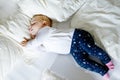 Cute adorable baby girl of 6 months sleeping peaceful in bed Royalty Free Stock Photo