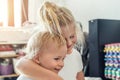 Cute adorable blond caucaian little sister hugging her toddler brother.couple of cheerful sibling playing indoor. Cute Royalty Free Stock Photo