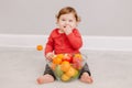 Cute adorable Caucasian baby boy eating citrus fruits. Finny child eating healthy organic snack. Solid finger food and