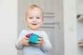 Cute adorable caucasian baby boy playing colorful toys at home. Happy child having fun building tower of soft rubber cubes. Royalty Free Stock Photo