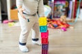 Cute adorable caucasian baby boy playing colorful toys at home. Happy child having fun building tower of soft rubber cubes. Royalty Free Stock Photo