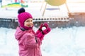 Cute adorable caucasian little girl winter portrait holding snowball in hands ready for snow fight at playground outdoor. Funny Royalty Free Stock Photo