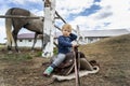 Cute adorable caucasian little pensive toddler portrait boy sitting on saddle on ground enjoy having fun riding supposed Royalty Free Stock Photo