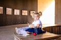 Cute adorable Caucasian toddler baby girl sitting and eating berries fruits. Funny child in park having healthy snack meal. Summer Royalty Free Stock Photo