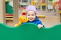 Cute adorable caucasian toddler boy enjoy having fun at outdoor playground. Portrait of happy little child playing ouside Royalty Free Stock Photo