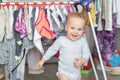 Cute adorable caucasian toodler boy laughing and having fun playing home with mess and clothes dryer on background. portrait of Royalty Free Stock Photo