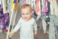 Cute adorable caucasian toodler boy laughing and having fun playing home with mess and clothes dryer on background. portrait of Royalty Free Stock Photo