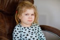 Cute adorable crying sad toddler girl. Little angry sleepy baby girl at home. Horrible terrible 3 years concept Royalty Free Stock Photo