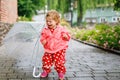 Cute adorable crying sad toddler girl on a walk. Little baby child going for walk with parents. frustrated healthy kid