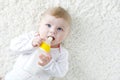 Cute adorable ewborn baby girl holding nursing bottle and drinking formula milk Royalty Free Stock Photo