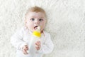 Cute adorable ewborn baby girl holding nursing bottle and drinking formula milk Royalty Free Stock Photo