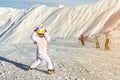 Cute adorable funny caucasian kid girl portrait in helmet, goggles and unicorn fun costume enjoy winter sport activities Royalty Free Stock Photo