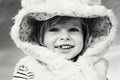 cute adorable funny smiling laughing Caucasian kid baby girl in fur coat