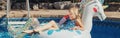 Cute adorable girl in sunglasses with drink lying on inflatable ring unicorn. Kid child enjoying having fun in swimming pool. Royalty Free Stock Photo