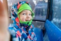 Cute adorable happy caucasian smiling small toddler kid boy enjoy ascent sitting inside ski lift gondola cable car and