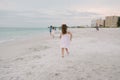 Cute Adorable Happy Young Little Girls in Pretty Dresses Playing On Vacation at the Tropical Beach by the Water on Destination Vac Royalty Free Stock Photo