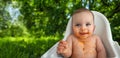 Cute adorable infant funny dirty baby trying to eat himself with fruit or vegetable puree smeared on his face. Baby Royalty Free Stock Photo