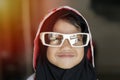 Cute adorable little baby girl looking at camera and smiling, happy Asian muslim girl wearing sunglasses Royalty Free Stock Photo