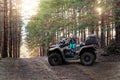 Cute adorable little blond caucasian toddler boy siiting on ATV quad motorcycle along rural country sand road on ranch Royalty Free Stock Photo