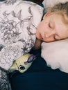 Cute adorable little child girl sleeping with favourite toy in a bed at home. Kid sleeping dreaming together with sleep soother Royalty Free Stock Photo