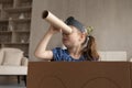 Cute adorable little girl in pirate hat looking in spyglass