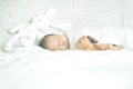 Cute adorable newborn baby boy wrapped or swaddle in a blanket, sleeping in bed Royalty Free Stock Photo