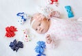 Cute adorable newborn baby with colorful bows. New born child, little girl looking surprised at the camera. Family, new Royalty Free Stock Photo