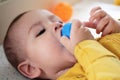 Cute adorable newborn baby playing with colorful rattle toy. baby with teether. six months old lovely baby portrait on Royalty Free Stock Photo