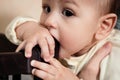 Cute adorable newborn baby playing with colorful rattle toy. baby with teether. six months old lovely baby portrait on Royalty Free Stock Photo