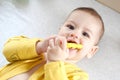 Cute adorable newborn baby playing with colorful rattle toy. baby with teether. six months old lovely baby portrait on Royalty Free Stock Photo