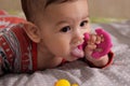 Cute adorable newborn baby playing with colorful rattle toy. baby with teether. six months old lovely baby portrait on Royalty Free Stock Photo