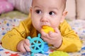 Cute adorable newborn baby playing with colorful rattle toy. baby with teether. six months old lovely baby portrait on Royalty Free Stock Photo