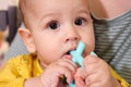 Cute adorable newborn baby playing with colorful rattle toy. baby with teether. six months old lovely baby portrait on Royalty Free Stock Photo