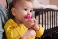 Cute adorable newborn baby playing with colorful rattle toy. baby with teether. six months old lovely baby portrait on Royalty Free Stock Photo