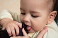 Cute adorable newborn baby playing with colorful rattle toy. baby with teether. six months old lovely baby portrait on Royalty Free Stock Photo