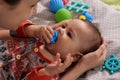 Cute adorable newborn baby playing with colorful rattle toy. baby with teether. six months old lovely baby portrait on Royalty Free Stock Photo