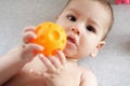 Cute adorable newborn baby playing with colorful rattle toy. baby with teether. six months old lovely baby portrait on Royalty Free Stock Photo