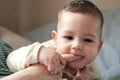 Cute adorable newborn baby playing with colorful rattle toy. baby with teether. six months old lovely baby portrait on Royalty Free Stock Photo