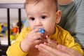 Cute adorable newborn baby playing with colorful rattle toy. baby with teether. six months old lovely baby portrait on Royalty Free Stock Photo