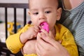 Cute adorable newborn baby playing with colorful rattle toy. baby with teether. six months old lovely baby portrait on Royalty Free Stock Photo