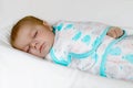 Cute little newborn baby girl sleeping wrapped in blanket Royalty Free Stock Photo