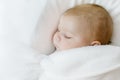 Cute little newborn baby girl sleeping wrapped in blanket Royalty Free Stock Photo