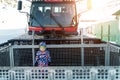 Cute adorable playful happy toddler boy inside red modern snowcat ratrack snowplow box grooming standing on peak alpine Royalty Free Stock Photo