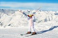 Cute adorable preschooler caucasian kid girl portrait with ski in helmet, goggles and unicorn fun costume enjoy winter sport Royalty Free Stock Photo