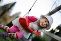 Cute adorable toddler girl swinging in domestic garden with soft plush toy. Happy healthy baby child in hat and dress Royalty Free Stock Photo